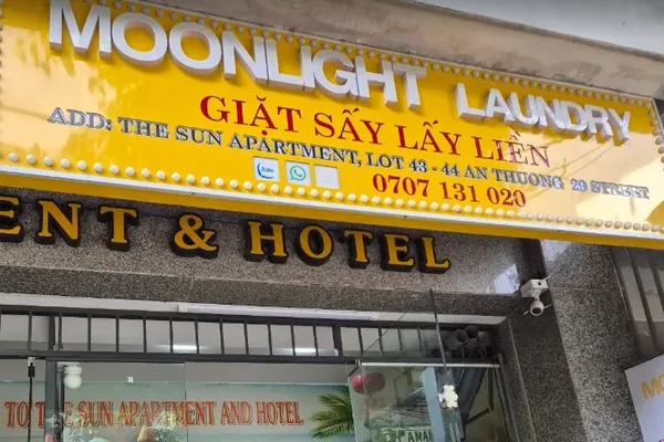 The Moonlight Laundry shopfront under its yellow sign, with washing machines visible inside