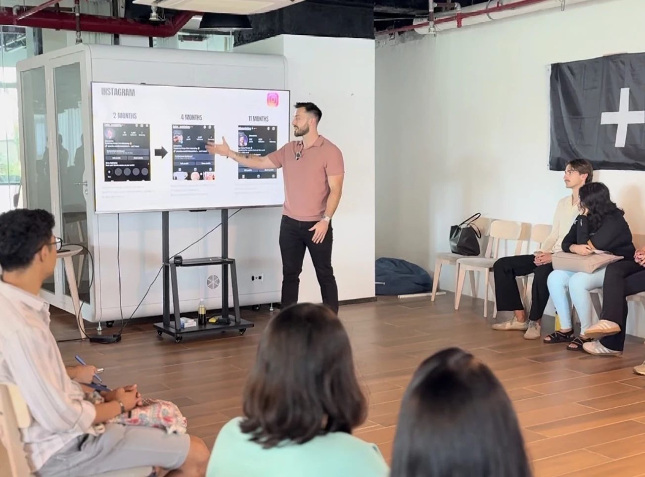 Jake teaching a content creation workshop, with participants and a presentation screen